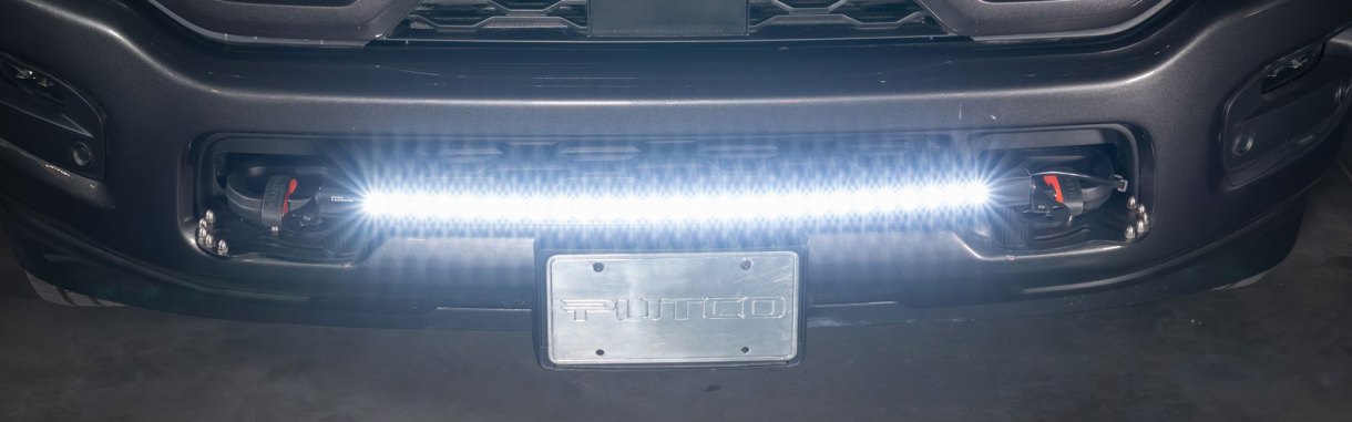 Denominator with Curved Light Bar Mounted to RAM 2500 front tow hooks